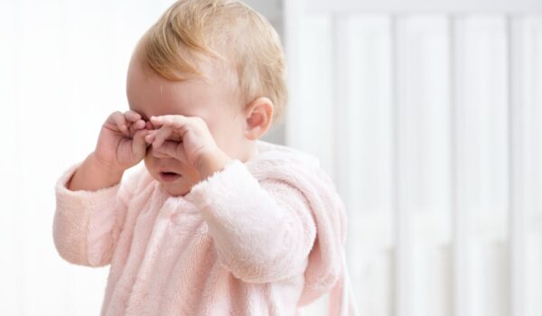 tired baby girl crying rubbing her eyes min درمانگاه کودک سالم